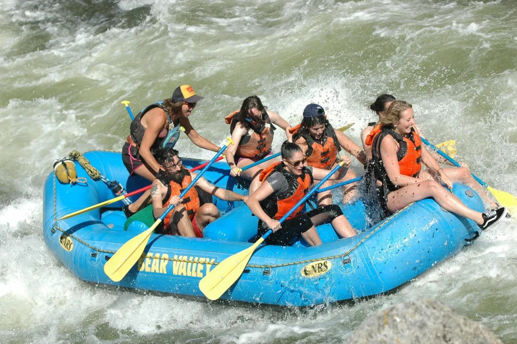 Group of rafters paddling together in an inflatable boat